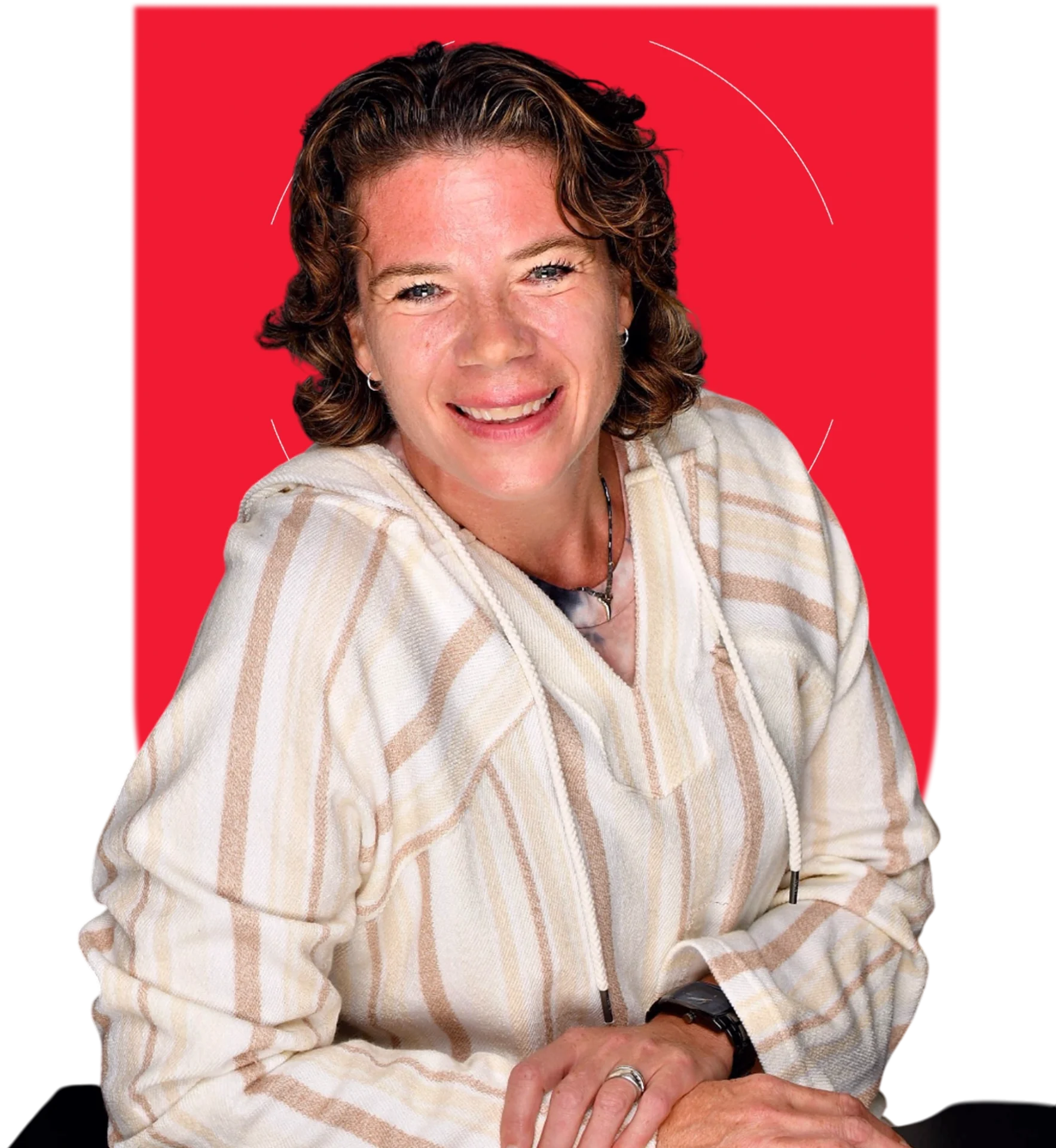 Smiling person in striped shirt, red background.